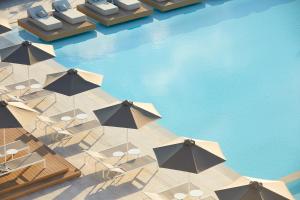 an overhead view of a pool with chairs and umbrellas at Vincci EverEden in Anavyssos