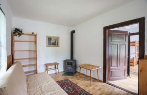 a living room with a door and a wood stove at Chatička - Spálov in Semily