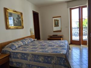 Postel nebo postele na pokoji v ubytování Hotel Corallo