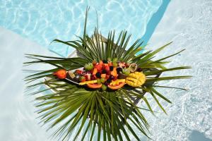 a tray of fruit and vegetables in a pool at Playa del Mar - Adults Only in Monopoli