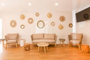 a living room with chairs and a couch and a table at Apartamentos Los Arcos in Santa Eularia des Riu