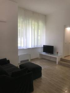 a living room with a couch and a tv at Residenza Idra in Segrate
