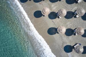 an overhead view of a beach with waves at Vincci EverEden in Anavyssos