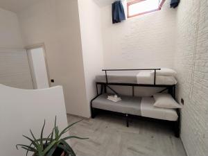 a small room with a bunk bed with a window at Duomo 8 - Borgo antico in Termoli