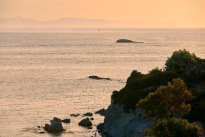 a view of the ocean at sunset at Vincci EverEden in Anavyssos
