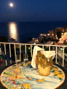 a table on a balcony with a view of the ocean at Villa Celentano in Positano