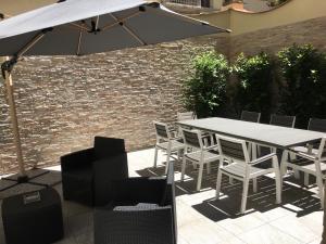 a table and chairs under an umbrella on a patio at Il Valentino Luxury Houses in Florence