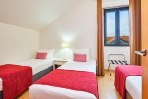 a hotel room with two beds and a window at Sintra Bliss A Part in Sintra