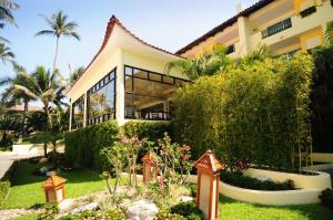 a house with a garden in front of it at Crown Paradise Club All Inclusive in Puerto Vallarta