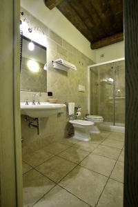 a bathroom with a sink and a toilet and a shower at Hotel Tenuta San Francesco in Barletta