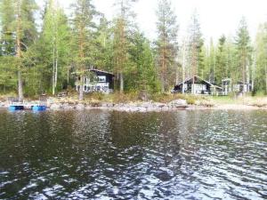 a view of a lake with houses in the background at Holiday Home Lähesniemi by Interhome in Hokkanen