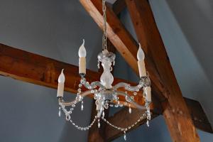a chandelier hanging from a wooden ceiling at Hotel De Villa in Dongen