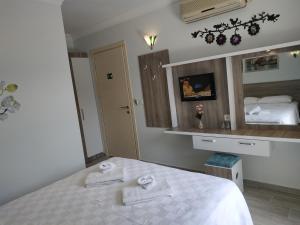 a bedroom with a bed and a large mirror at Hotel Mico in Dalyan
