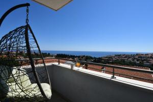 a hammock on a balcony with a view of the ocean at Dubrovnik Icy Guest House in Dubrovnik