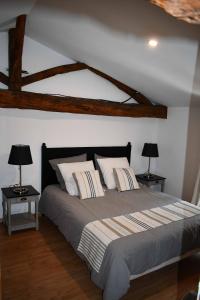 a bedroom with a large bed with two lamps at La Marcillande in Saint-Cyprien
