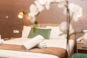 a bedroom with a bed with a towel on it at Skadarlija Suites in Belgrade