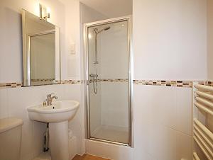 a white bathroom with a sink and a shower at The Elm @ Short Stays in Basingstoke