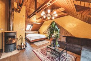 a living room with a couch and a fireplace at Apartmány Black Stork Golf in Veľká Lomnica