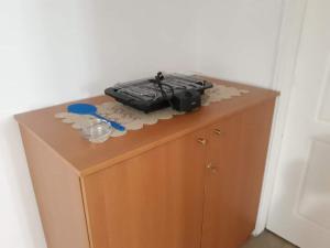 a suitcase sitting on top of a wooden cabinet at Dimitris house in Kalabaka
