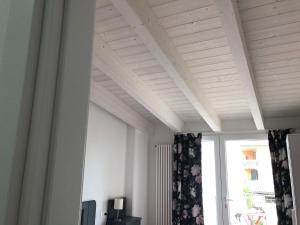 Pokój z białym sufitem i oknem w obiekcie Corte del Garda Home w mieście Castelnuovo del Garda