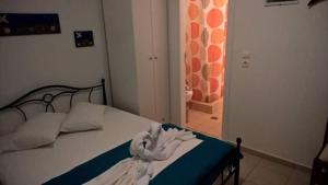 a bedroom with a bed and a hallway with a bathroom at Vigles in Adamantas
