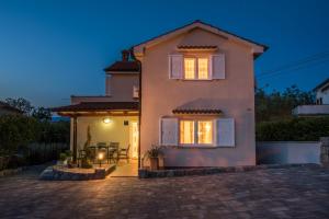 a house with a patio in front of it at Villa Marina in Malinska
