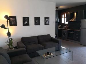 a living room with a couch and a glass table at Loizou Holdings Flat 301 in Larnaca