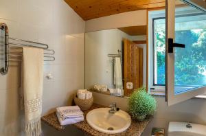 a bathroom with a sink and a window at O Casal das Árbores in Santiago de Compostela +27 photos