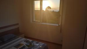 a bedroom with a bed and a window at Carnota PLAYA a 100 metros in Carnota