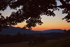 a sunset with mountains in the background at Czarny Dział in Wysowa-Zdrój