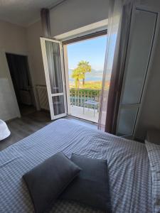 a bedroom with a bed with a view of the ocean at B&B Panorama Iseo in Iseo