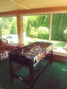 a pool table sitting in a room with a window at Relax in Polańczyk
