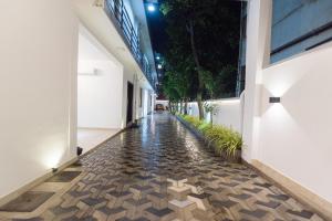 an empty corridor of a building with a cobblestone floor at Viveka Hotel Colombo in Colombo