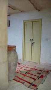 an empty room with a door and a floor with a rug at Dar Zahia in Taroudant