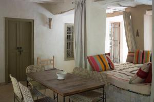 a living room with a table and a couch at Dar Zahia in Taroudant