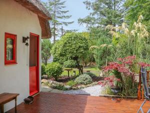 a front porch of a house with a garden at Mary Rose Cottage in Castleisland