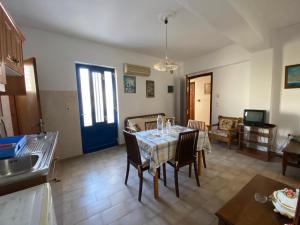 cocina y comedor con mesa y sillas en Blue Sky Apartments, en Karpathos