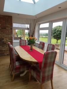 a dining room with a wooden table and chairs at Grooms Cottage in Horncastle