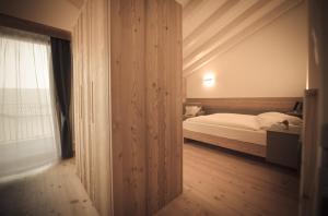 a bedroom with a white bed and a window at Agritur Renetta in Tassullo