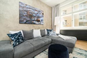 a living room with a couch and a painting on the wall at Charming apartment in famous area in Prague