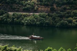 a boat in the water with at Ventozelo Hotel & Quinta in Ervedosa do Douro