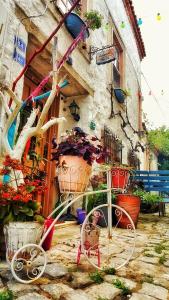 a bike parked in front of a building with flowers at Lilyum Alaçatı - Taş Ev in Alacati