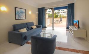 a living room with a blue couch and a table at Apartamento Vista Lotos in Puerto de la Cruz