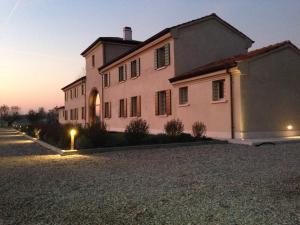 a large pink building with a street light in front of it at Corte Motte in Pegognaga