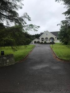 een groot wit huis met een oprit bij Kerry Air in Killarney