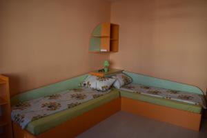 a small room with two beds and a table at Одеса 37 in Sozopol