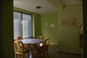 a dining room with a table and chairs and a window at Одеса 37 in Sozopol