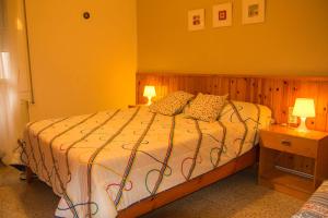a bedroom with a large bed with two lamps at Apartamento familiar con Wifi in Navás