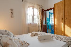 um quarto com uma cama com toalhas em Casa Stella Di Madel em Flumini di Quartu