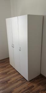 a white cabinet in a room with a wooden floor at APP-AMELIJAS in Zambratija